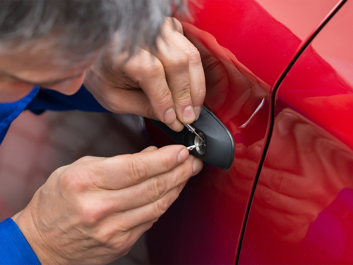 Locksmith working on a car lock.