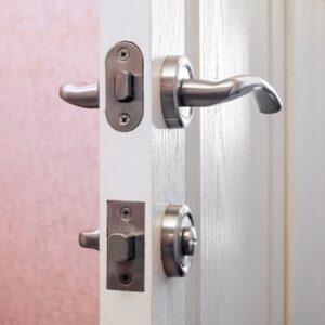 Deadbolt and door handle on a door left ajar