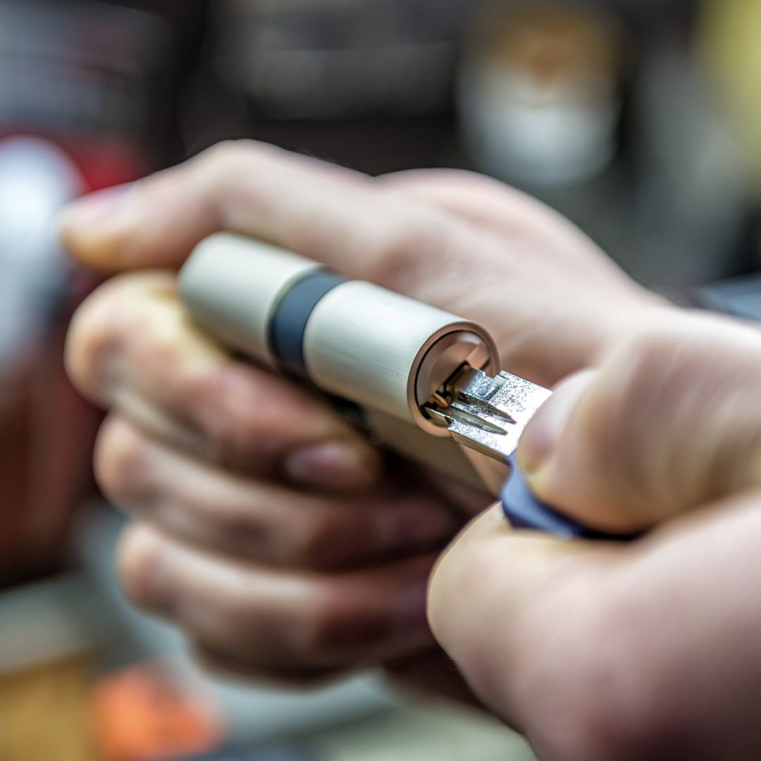 A locksmith working on the interior lock mechanism