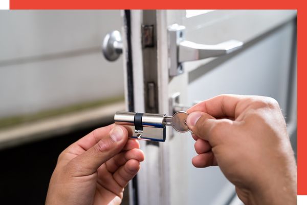 A locksmith working on a door