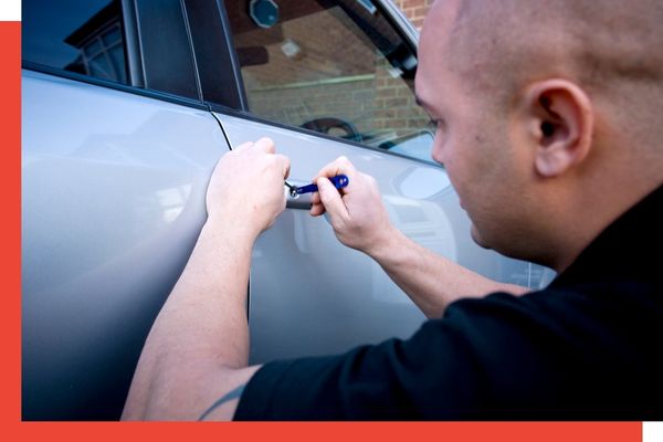 A locksmith unlocking a car