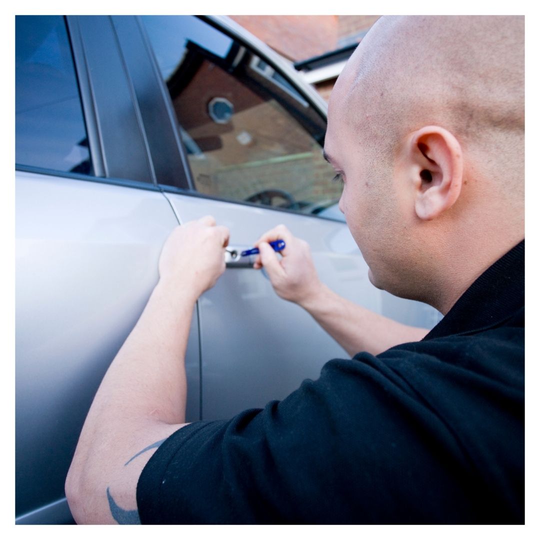 locksmith working on car