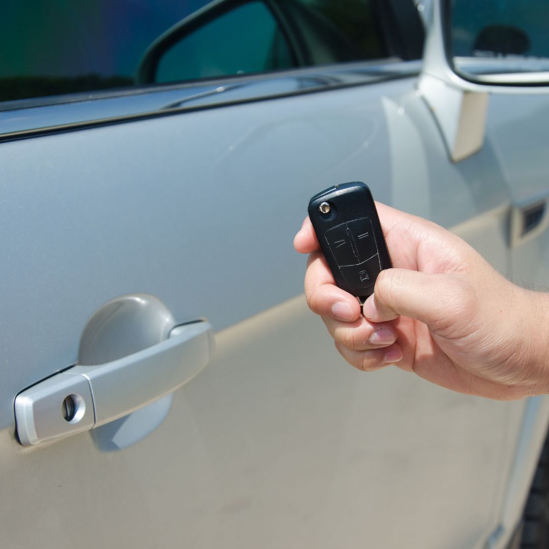 Car key unlocking a car