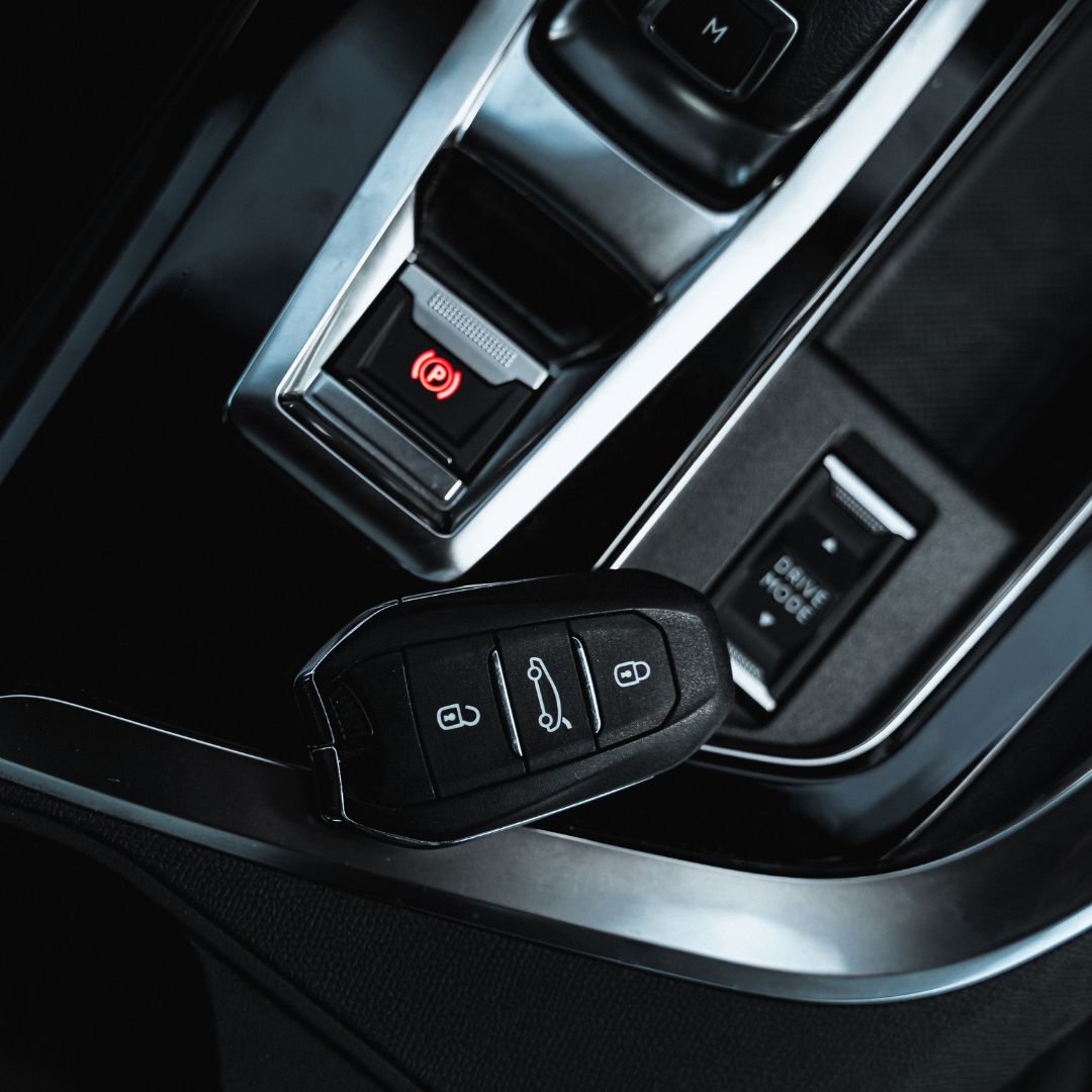 Car key fob on car center console.