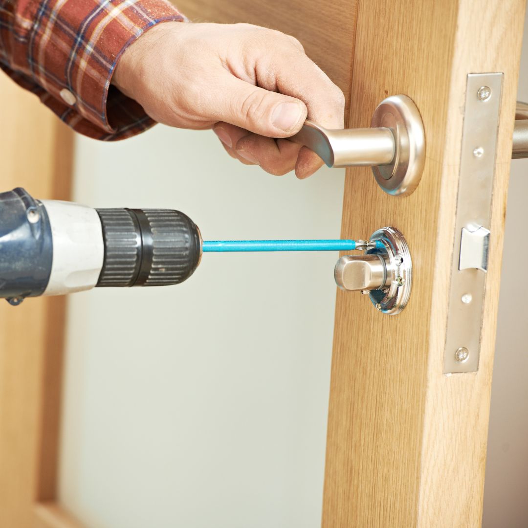 locksmith installing new lock on door