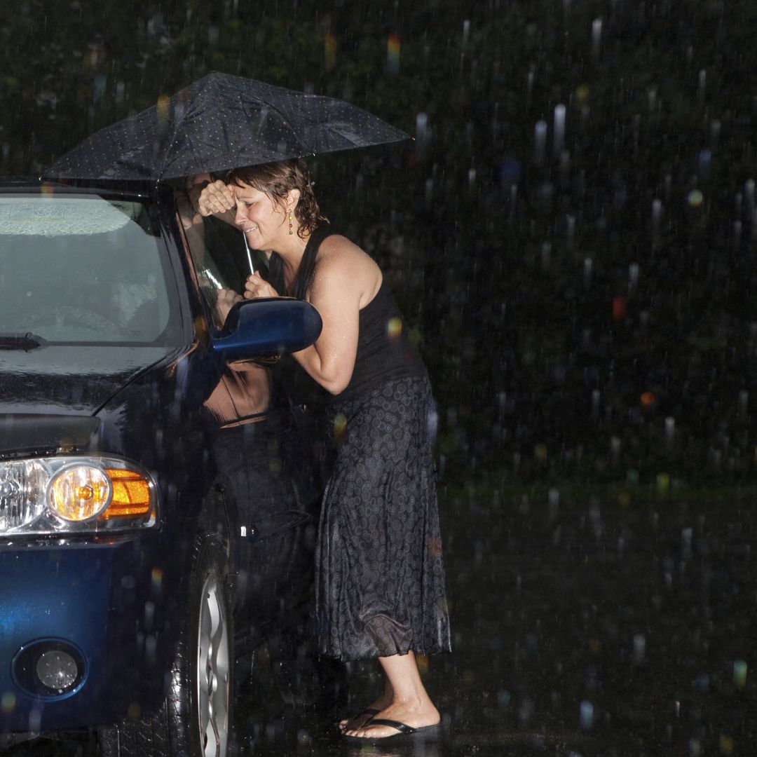 woman in the rain locked out of her car